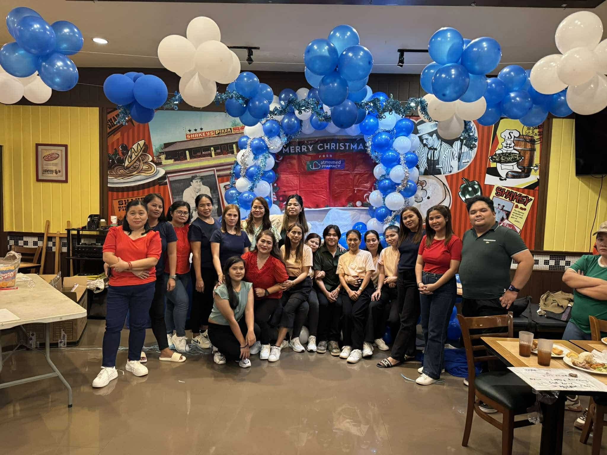 AtmosMed pharmacy team celebrating Christmas together, showing our community spirit